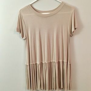 Cream short sleeved top with ruffled bottom